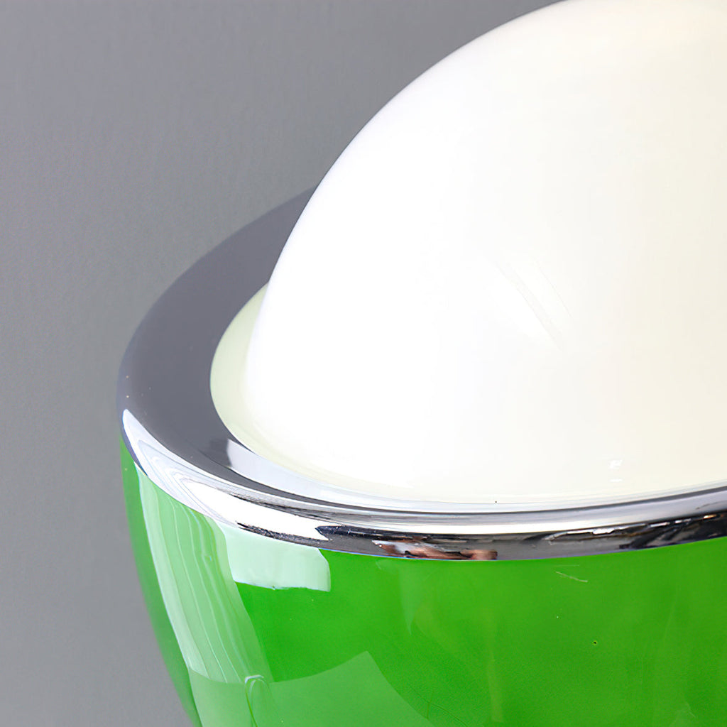 Close view of the white glass dome and the polished chrome rim on the green version of this Clérachic table lamp.
