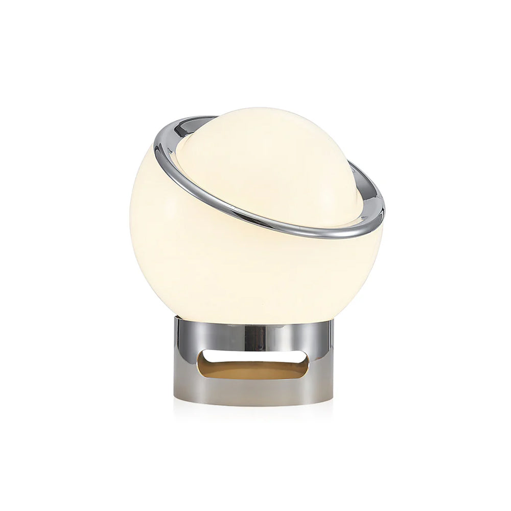 Lit white Clérachic table lamp with a tilted chrome ring and a slotted chrome base, shown on a plain white backdrop.