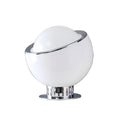 White glass Clérachic table lamp with a tilted chrome ring and a ribbed chrome base on a flat chrome plate, on a white backdrop.