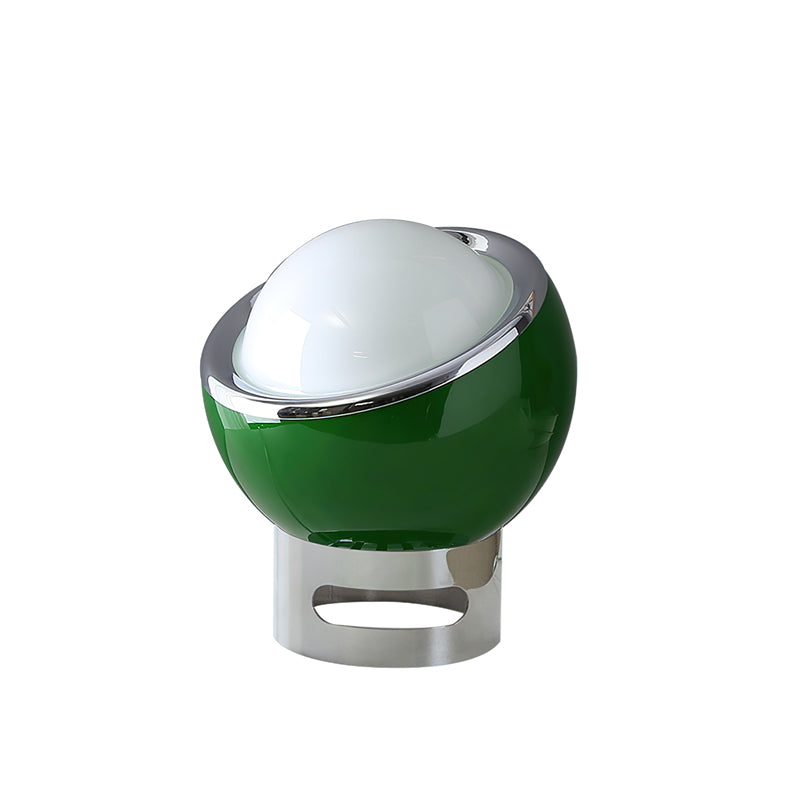 Dark green Clérachic table lamp with a white dome and chrome ring, on a chrome base with an oval cut-out, on a white backdrop.