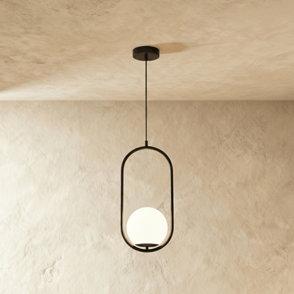 Clérachic Cells pendant light in Oval, Black, a matte black oval frame cradling a frosted glass globe shade.