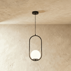 Clérachic Cells pendant light in Oval, Black, a matte black oval frame cradling a frosted glass globe shade.