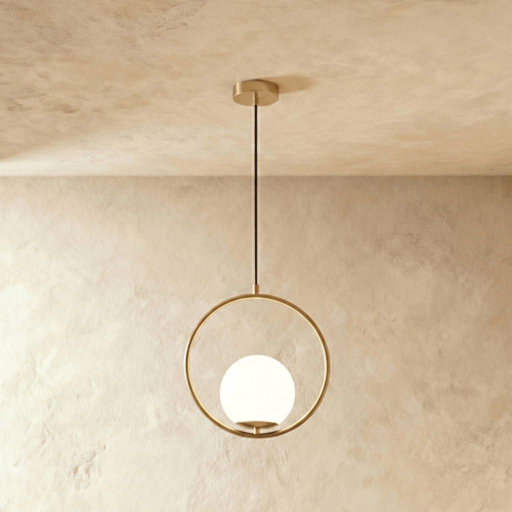 Clérachic Cells pendant light in Circle, Brass, a warm brass ring cradling a frosted glass globe from a black cord.