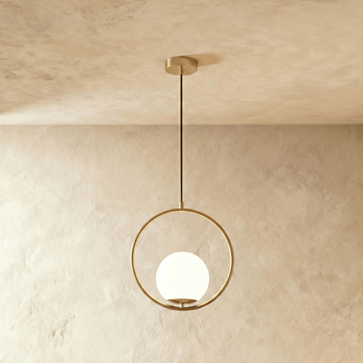 Clérachic Cells pendant light in Circle, Brass, a warm brass ring cradling a frosted glass globe from a black cord.
