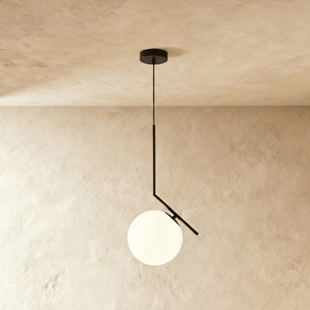 Clérachic Cells pendant light in the Canted profile, Black, an angled matte black rod holding a frosted glass globe.