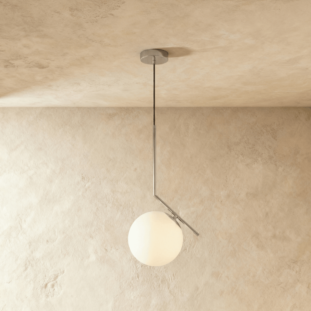 Clérachic Cells pendant light in the Canted profile, Chrome, an angled nickel rod holding a frosted glass globe.