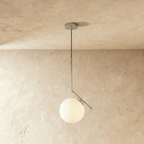 Clérachic Cells pendant light in the Canted profile, Chrome, an angled nickel rod holding a frosted glass globe.