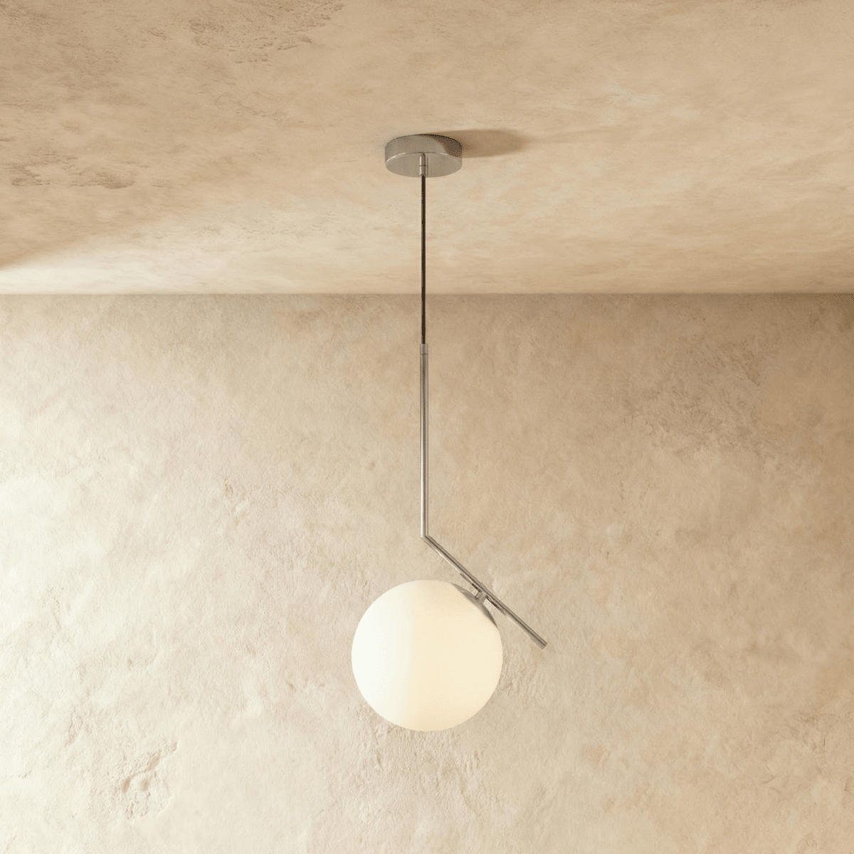 Clérachic Cells pendant light in the Canted profile, Chrome, an angled nickel rod holding a frosted glass globe.