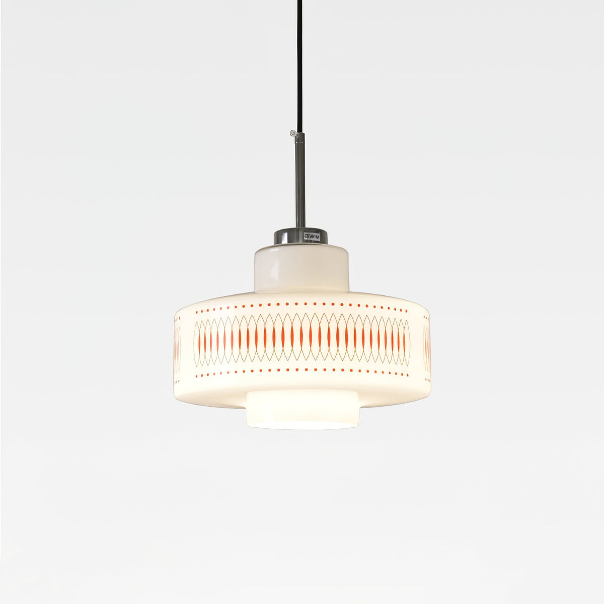 Clérachic pendant with a white opal glass shade, orange lattice print and a chrome cap, lit softly on a plain light backdrop.