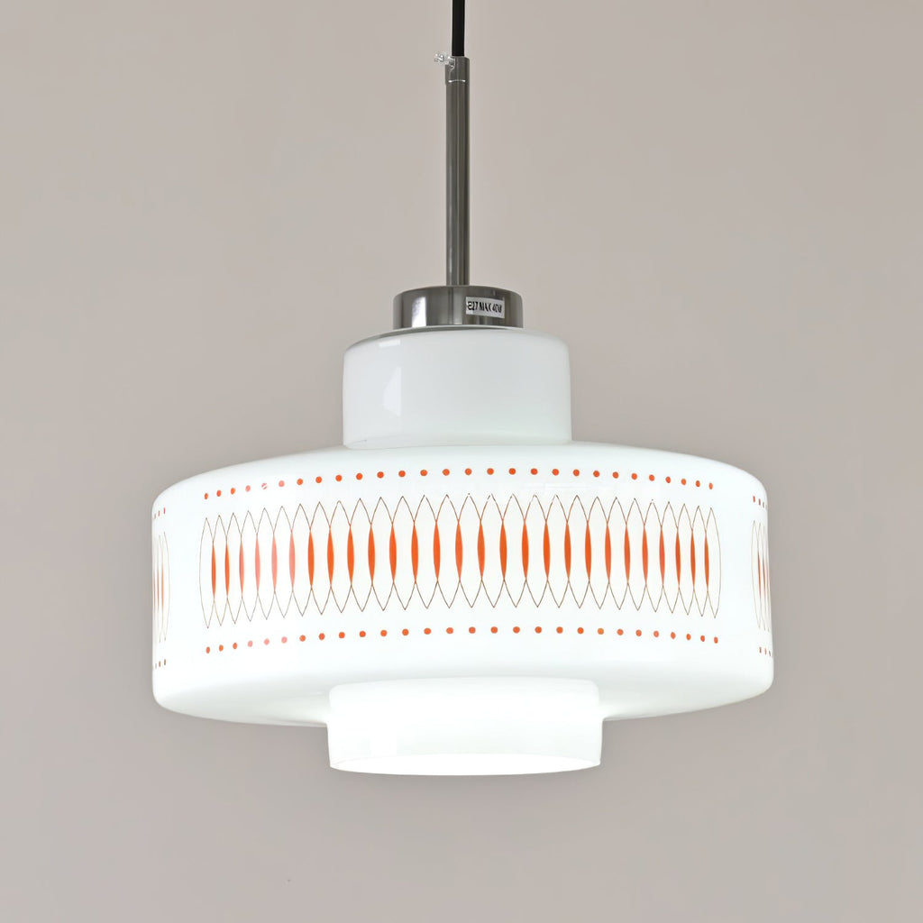 Close view of the stepped opal glass shade and orange printed band on this Clérachic pendant, with a chrome cap above.