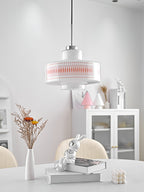Clérachic pendant with a printed opal shade hangs before a white shelf, with dried flowers, a cabinet and cream chairs below.