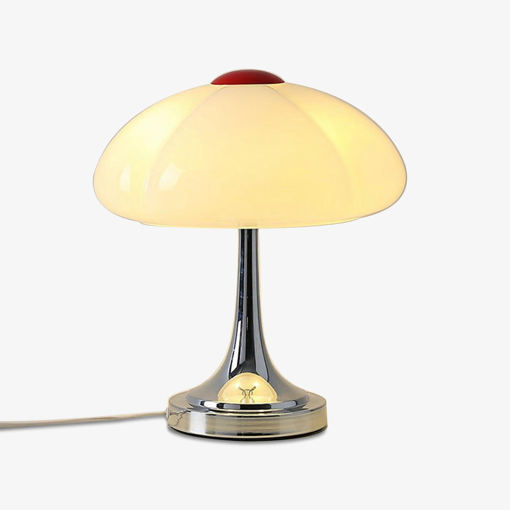 Product shot of this Clérachic lamp lit on a white backdrop, its cord running to the left from the chrome base.