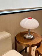 This Clérachic table lamp on a round walnut side table in a cream-toned corner, seen from a few steps back.