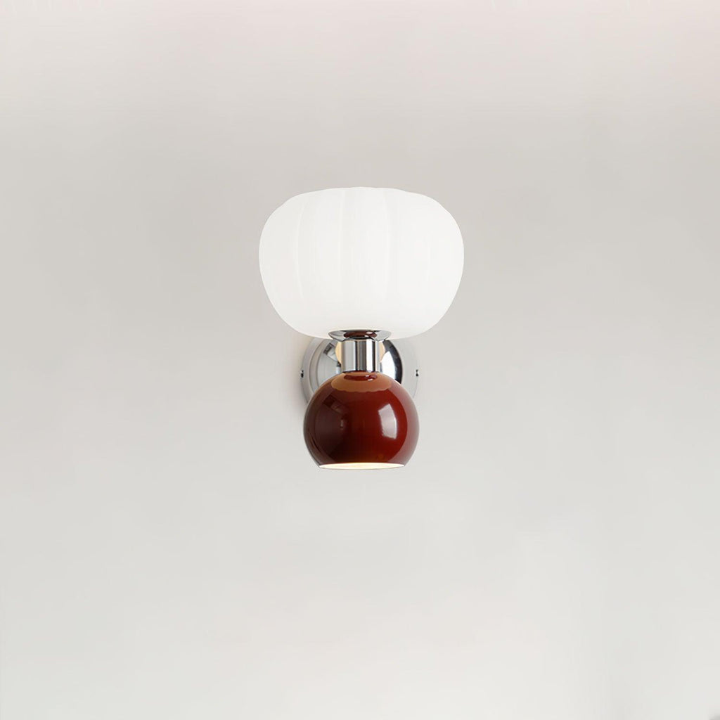 A deep red ball under a ribbed white glass shade on this Clérachic chrome wall light, shown on a plain pale wall.
