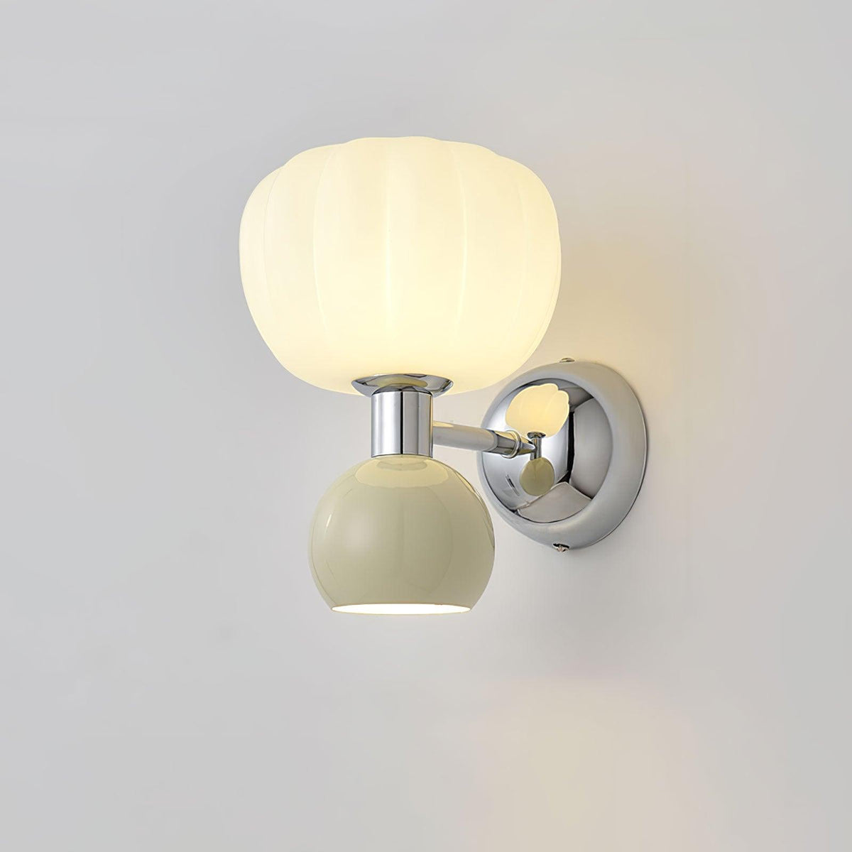 Large view of this Clérachic chrome wall light with a pale sage-grey ball, a ribbed glass shade and a round chrome back plate.