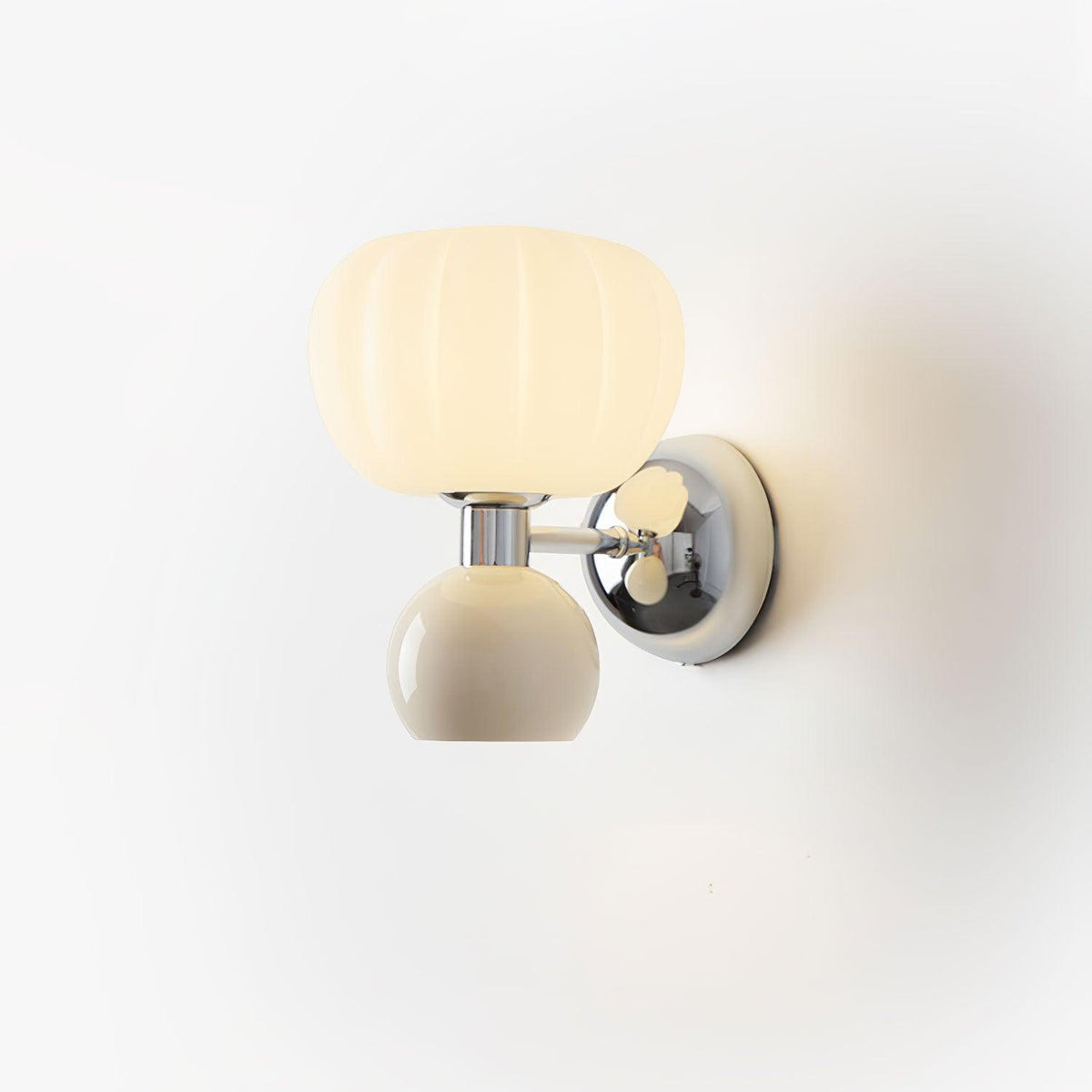 Cut-out view of this Clérachic chrome wall light with a cream ball and ribbed glass shade, glowing softly on a white wall.