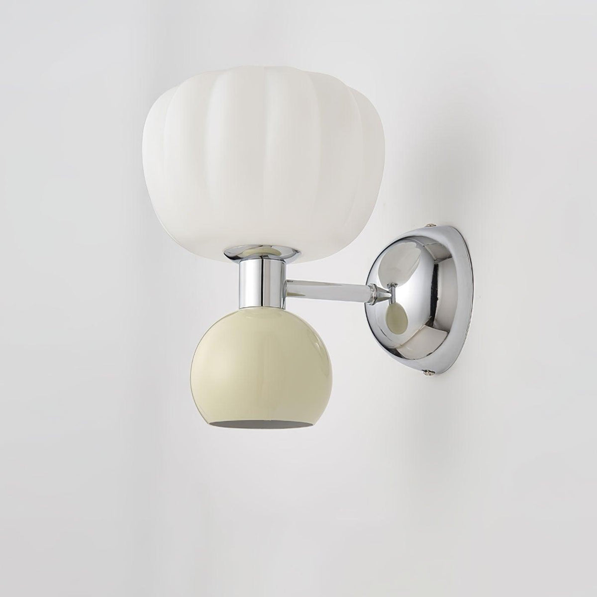 Close view of this Clérachic chrome wall light with a cream ball, a ribbed white glass shade and a round chrome back plate.