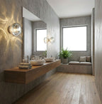 Above a floating wooden vanity in a concrete-walled bathroom, this Clérachic wall light casts a star-like pattern on the wall.