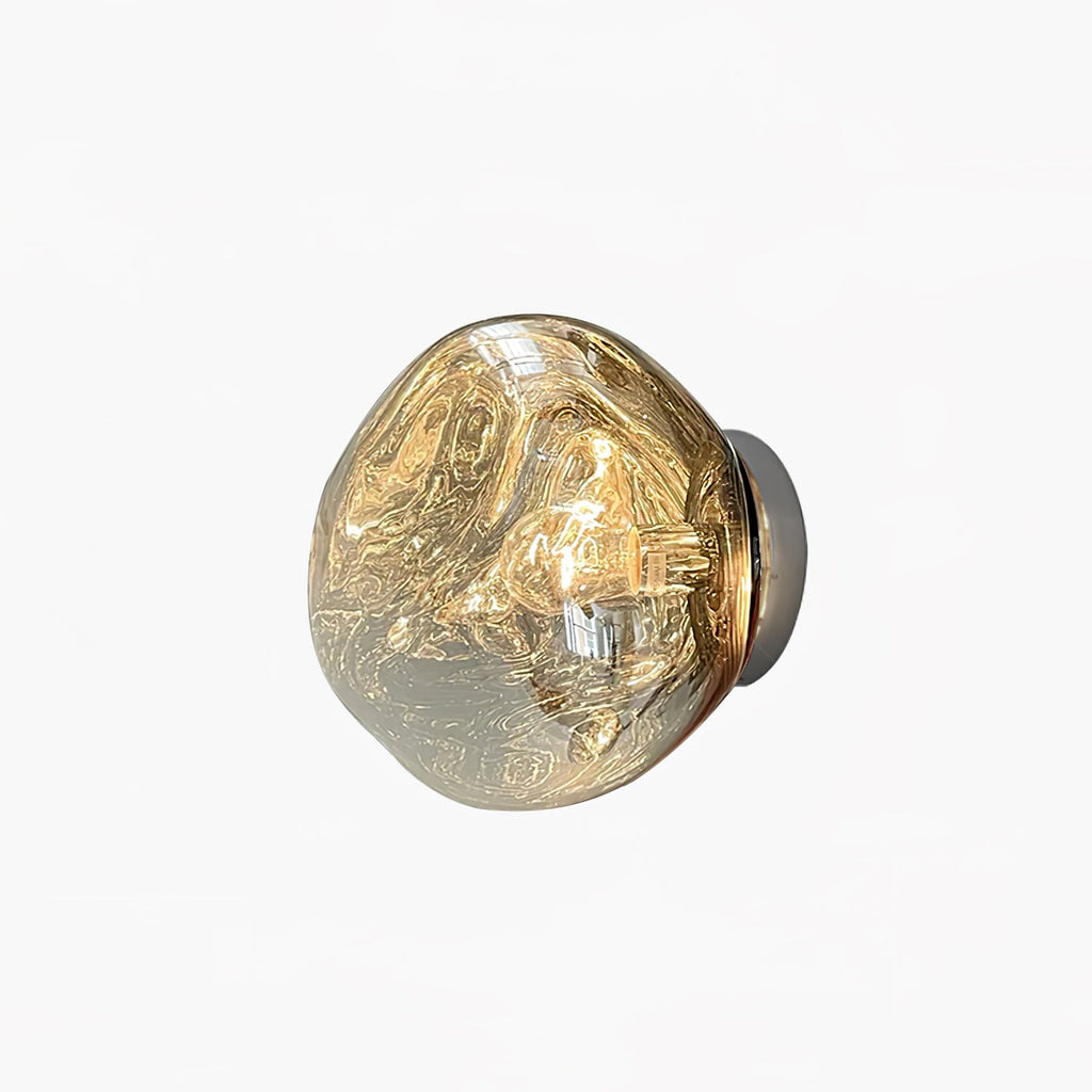 A Clérachic wall light with a melted-glass shade in a smoky champagne tone, on a plain white backdrop.