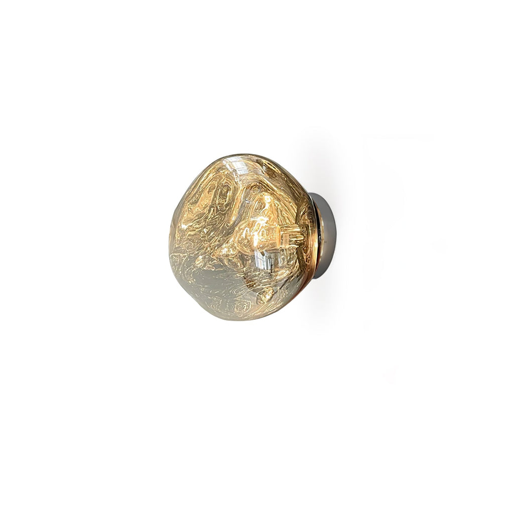 The gold-tone Clérachic wall light seen from a lower angle, with a pale champagne shade on a white background.