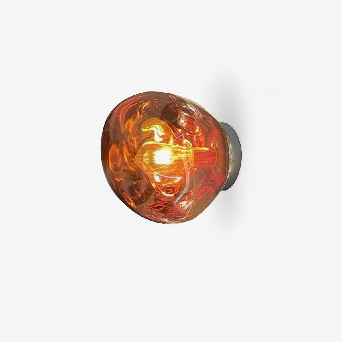 A Clérachic wall light with a copper-toned glass shade and a glowing filament bulb, on a pale grey background.