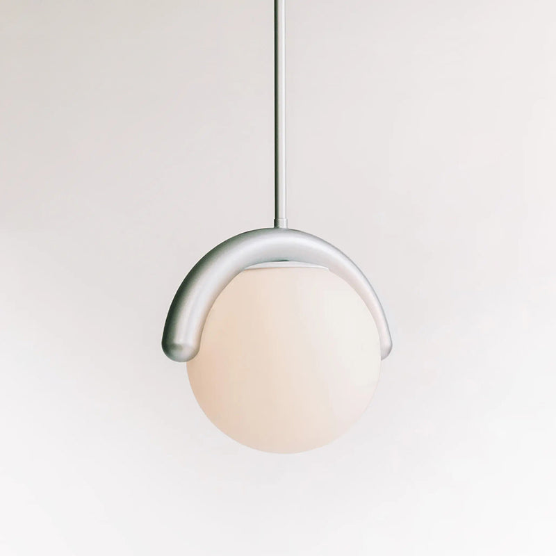 Clérachic Citheis single pendant on white, opal glass globe cradled by a curved metal hook.