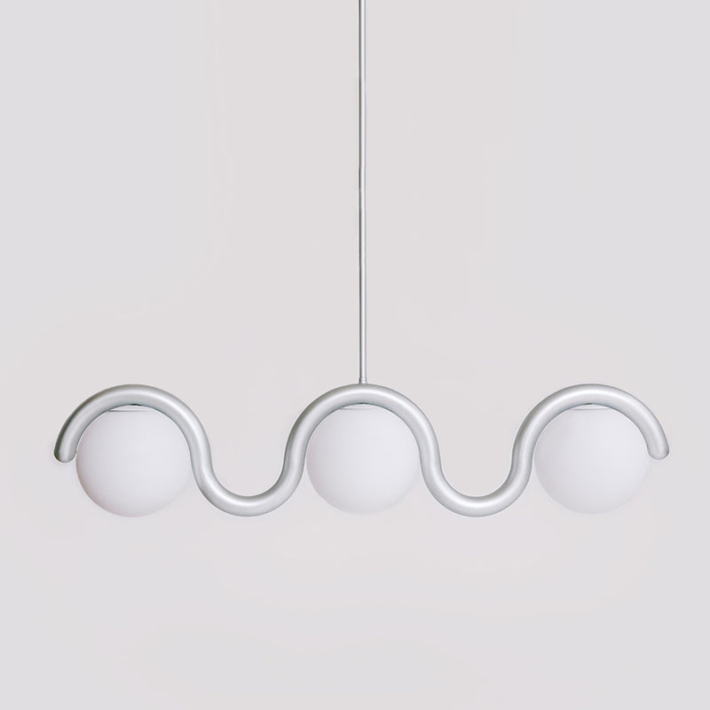 The Clérachic Citheis three-head chandelier in silver, opal globes spaced along the wave.