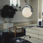 The Clérachic Citheis single pendant in a plant-filled loft above a record player and sofa.