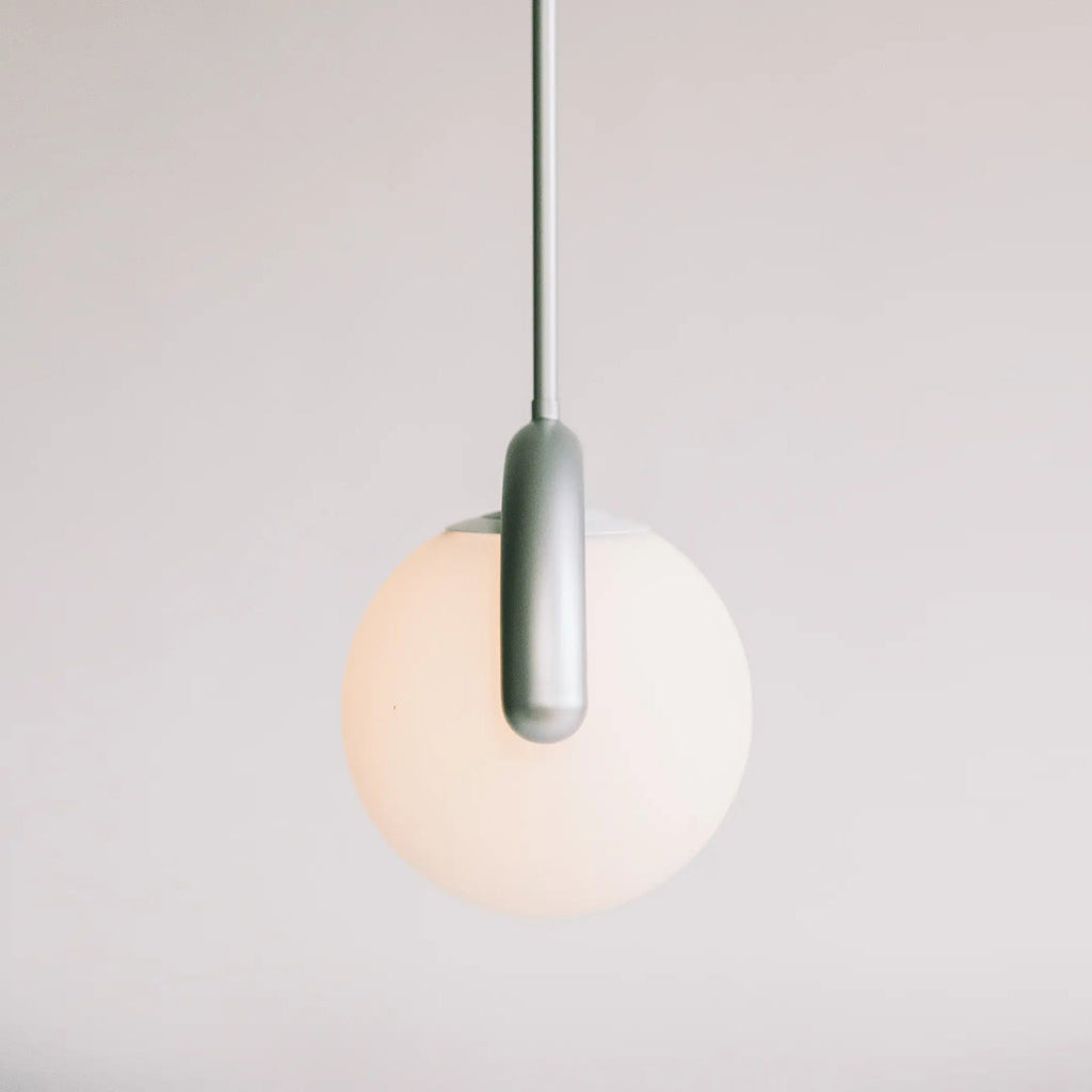 The Clérachic Citheis single pendant unlit, showing the soft green-grey hooked arm.