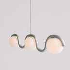 Clérachic Citheis three-head chandelier in silver on grey, globes nested in each curve.