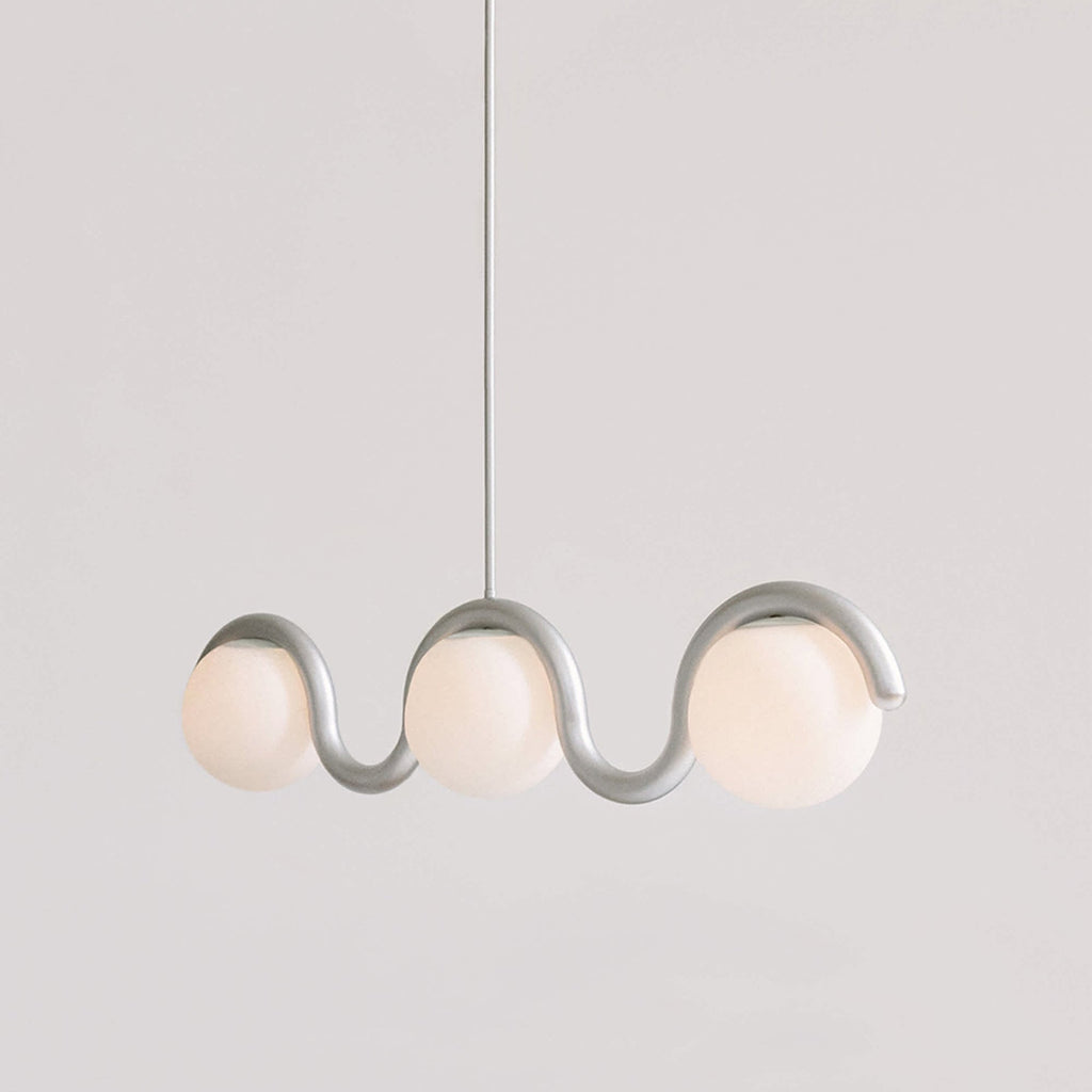 Clérachic Citheis three-head chandelier in silver, wave rail dipping between the globes.