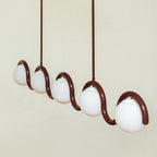 The Clérachic Citheis five-head chandelier angled on cream, globes stepping along the wave.