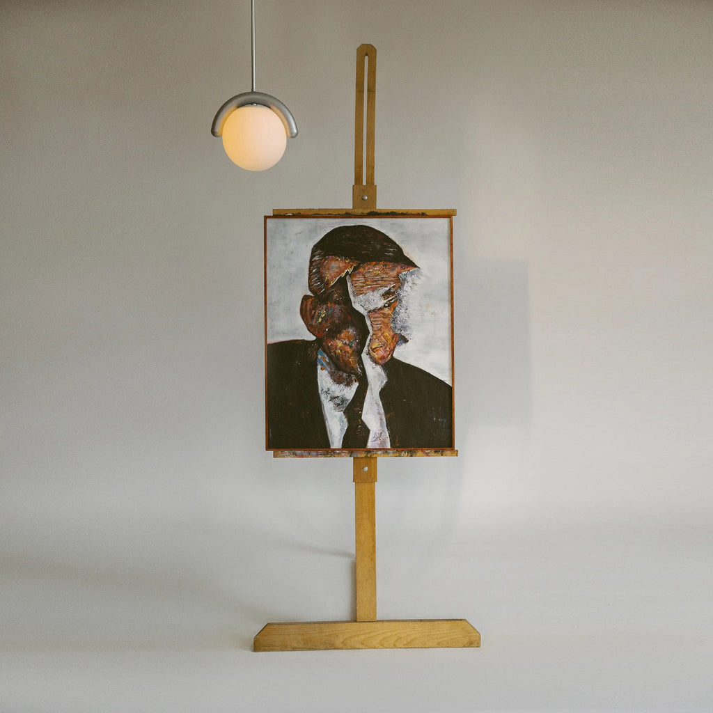 The Clérachic Citheis single pendant hung above a framed portrait propped on an easel.