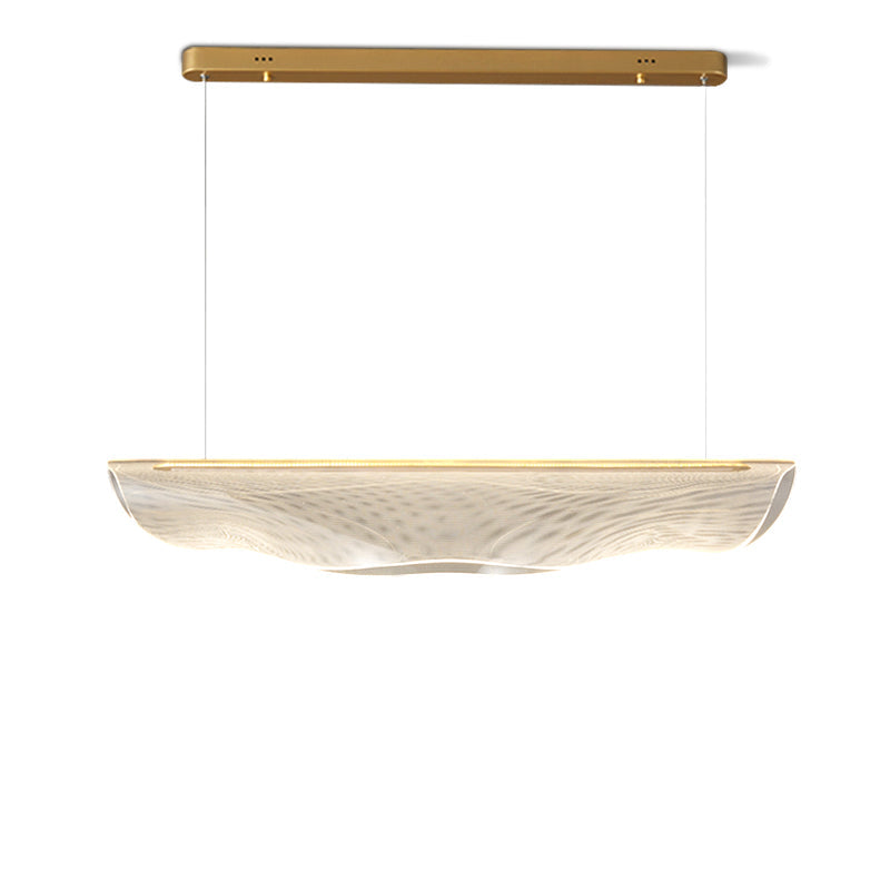 Cut out on white, this Clérachic pendant light shows its gold canopy bar, two thin suspension wires and a clear, rippled shade.