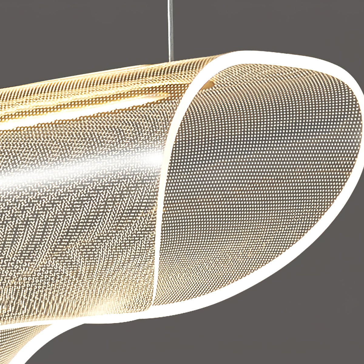 Close view of the clear, dotted acrylic shade on this Clérachic pendant light, its curled end edged with a bright strip of light.