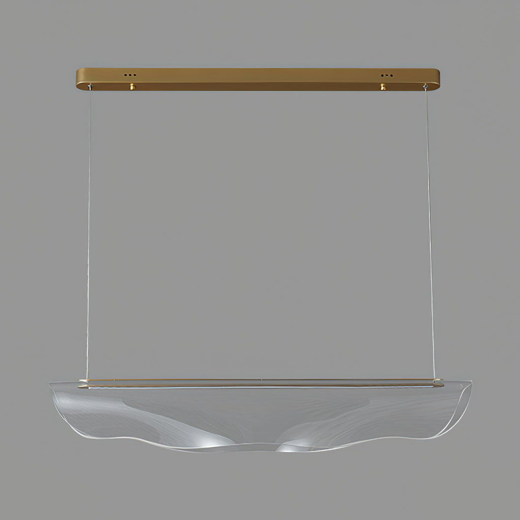 Unlit, this Clérachic pendant light hangs on a mid-grey backdrop, the shade clear and rippled under a gold canopy bar.