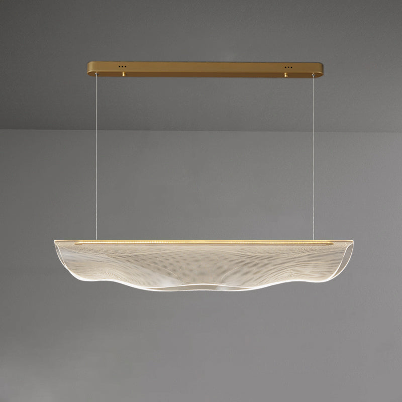 Same lit Clérachic pendant light on grey, viewed straight on, with the shade and its wavy lower edge softly glowing.