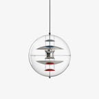 This Clérachic clear acrylic sphere pendant hangs on a black cord against a plain light backdrop, with chrome discs and red dishes stacked inside.