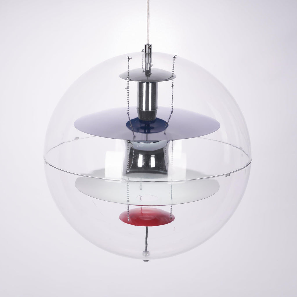 Close view of the layered chrome and white discs, blue ring and red dish inside this Clérachic acrylic sphere pendant.