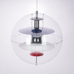 Close view of the layered chrome and white discs, blue ring and red dish inside this Clérachic acrylic sphere pendant.
