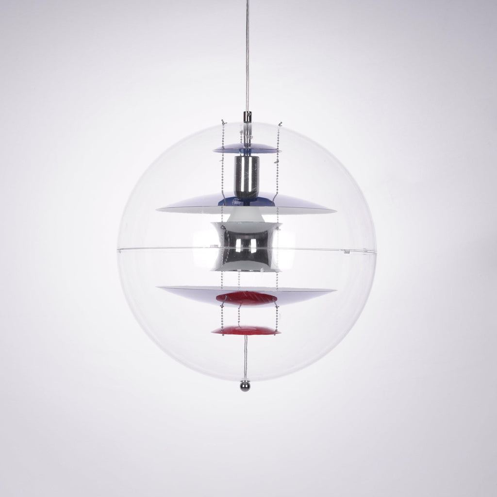 This Clérachic sphere pendant hangs on a clear cord against a soft grey-lilac backdrop, with a red dish at the base of the stack.