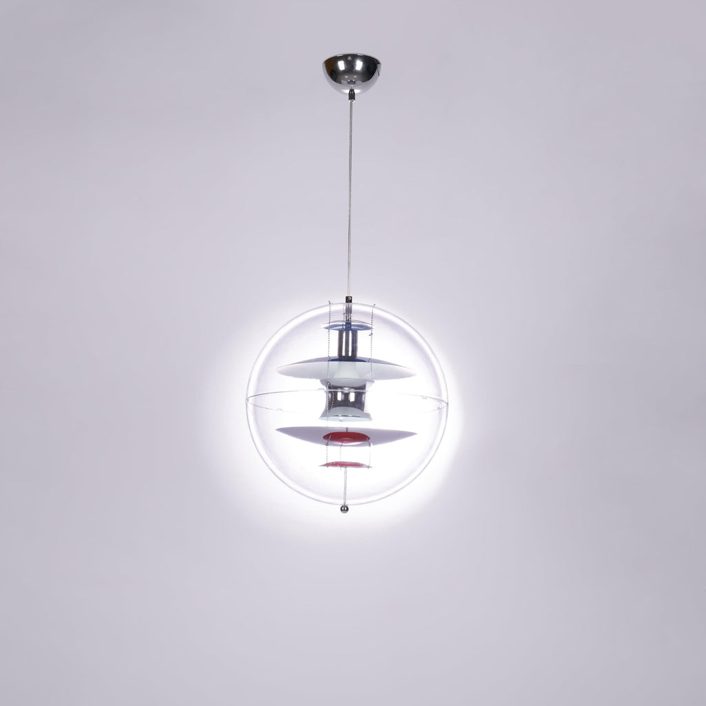 Seen from below with a bright halo of light around it, this Clérachic sphere pendant hangs from a chrome ceiling canopy.