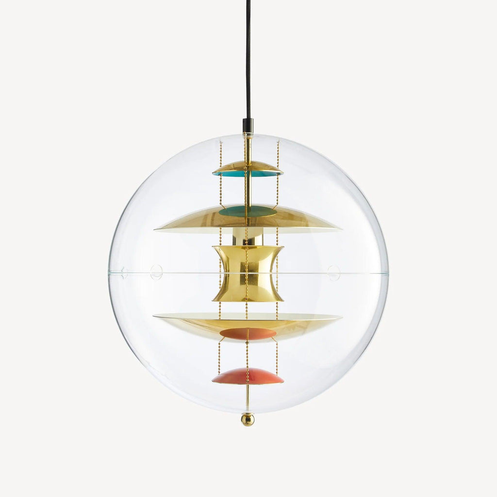 A Clérachic sphere pendant in gold on an off-white backdrop, with brass discs and coral dishes hanging on chains inside the clear sphere.