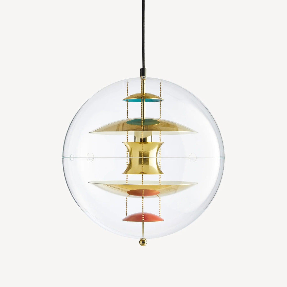 A Clérachic sphere pendant in gold on an off-white backdrop, with brass discs and coral dishes hanging on chains inside the clear sphere.