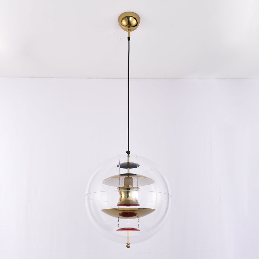 Seen close to the gold canopy, this Clérachic sphere pendant glows with brass-toned discs, a white upper disc and red dishes.