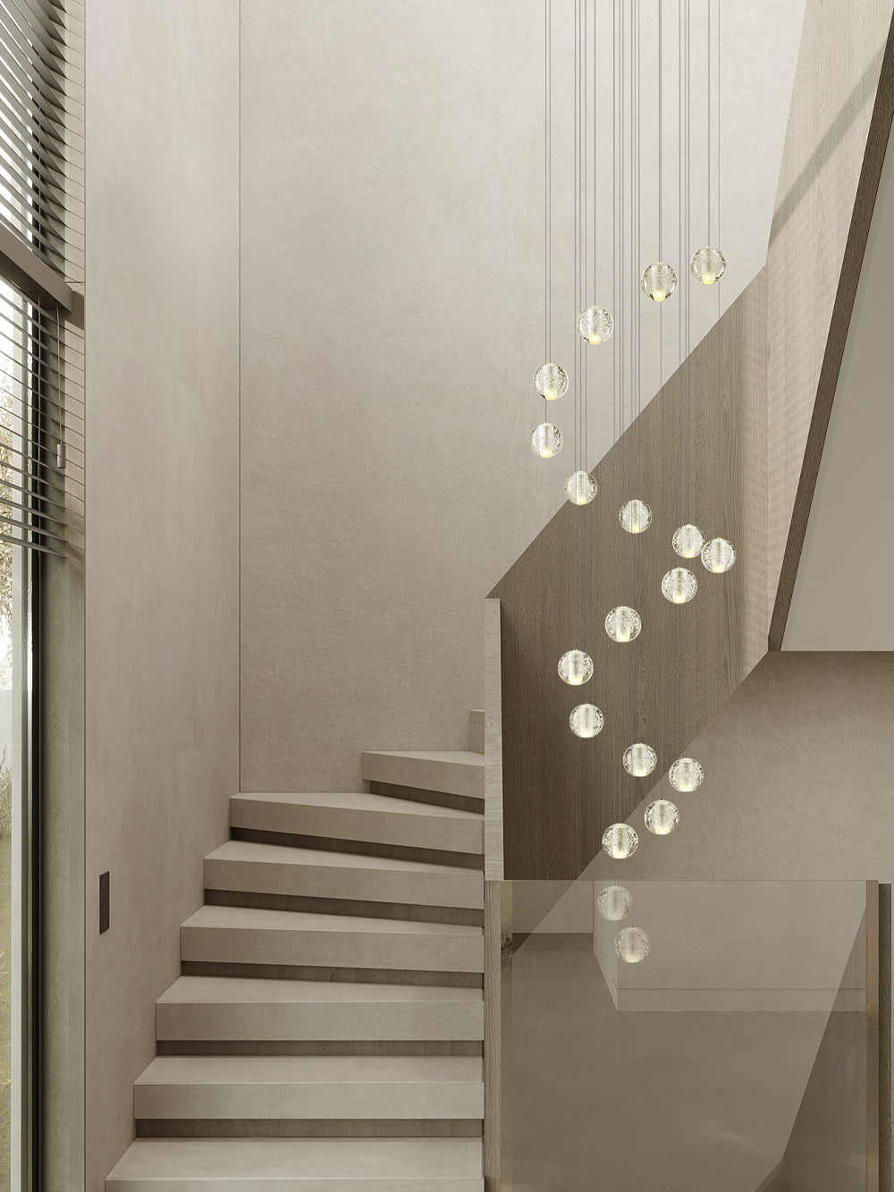 Pale spheres of this Clérachic pendant light trace a slow curve beside a stone staircase with a glass balustrade.