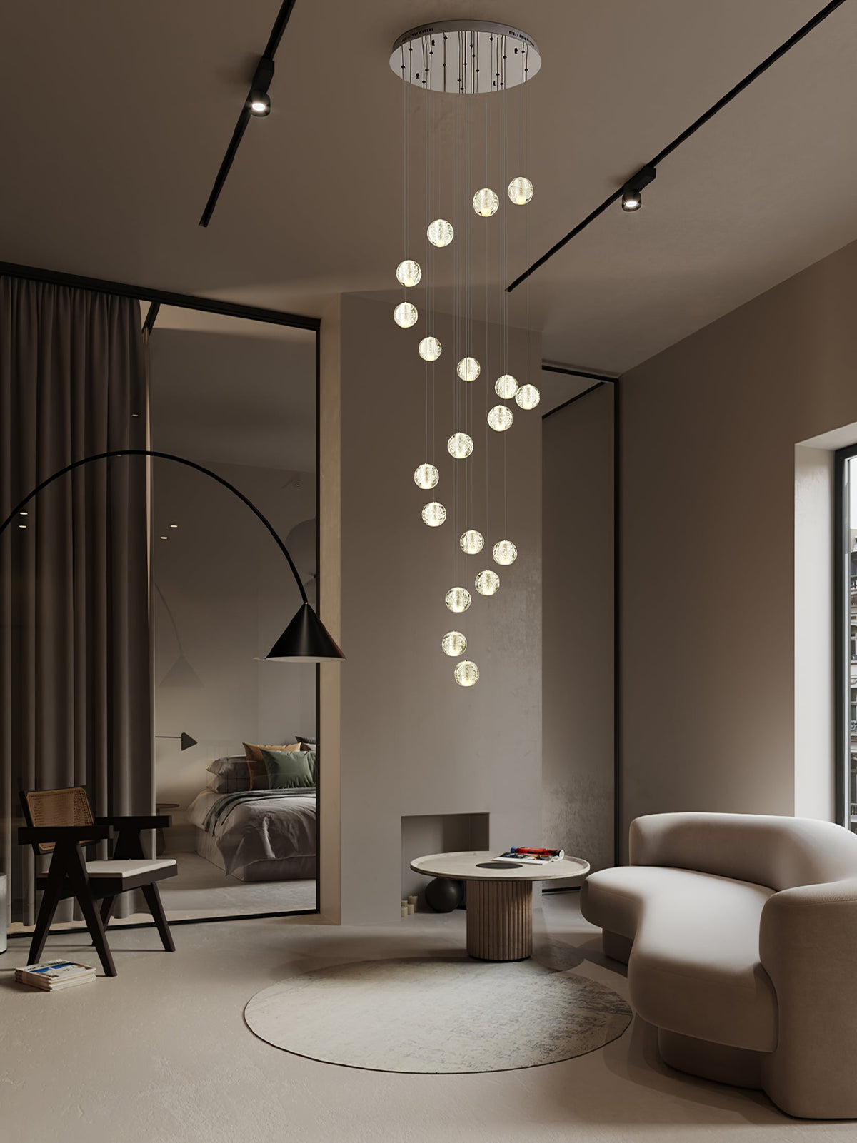 A spiral of lit glass spheres from this Clérachic pendant light drops from a round ceiling plate into a taupe living room.