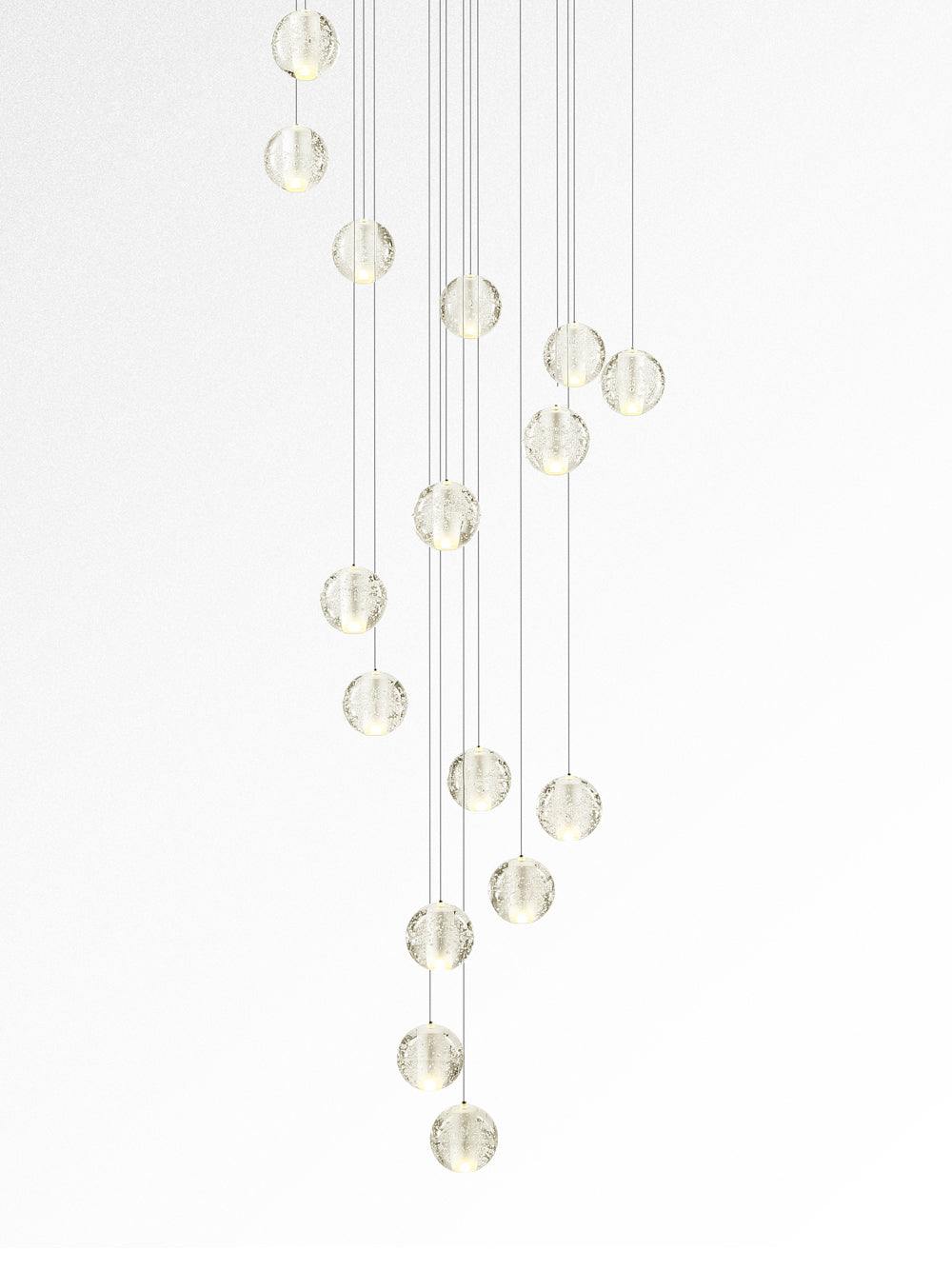 This Clérachic pendant light on white, a tall trail of softly lit clear spheres hung at staggered heights.