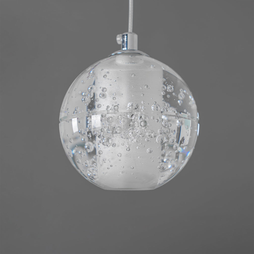 One unlit sphere of this Clérachic pendant light on a chrome cap and white cord, with fine bubbles in the clear glass.