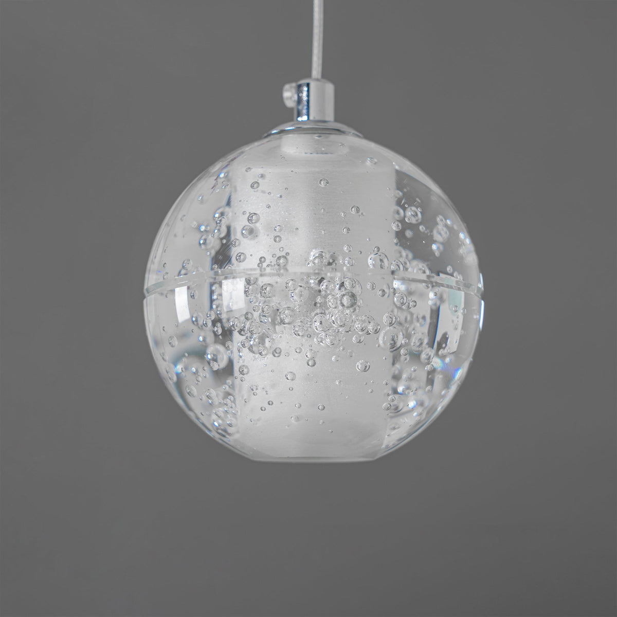 One unlit sphere of this Clérachic pendant light on a chrome cap and white cord, with fine bubbles in the clear glass.